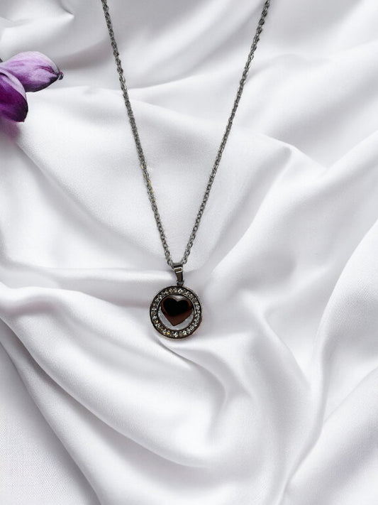Presenting our Sparkle Heart Necklace – where elegance meets timeless charm. This necklace features a stainless steel composition with a luxurious gold finish, offering enduring beauty and resilience. At its center is a captivating heart, encased within a circle of shimmering cubic zirconia stones that catch the light with every movement. 