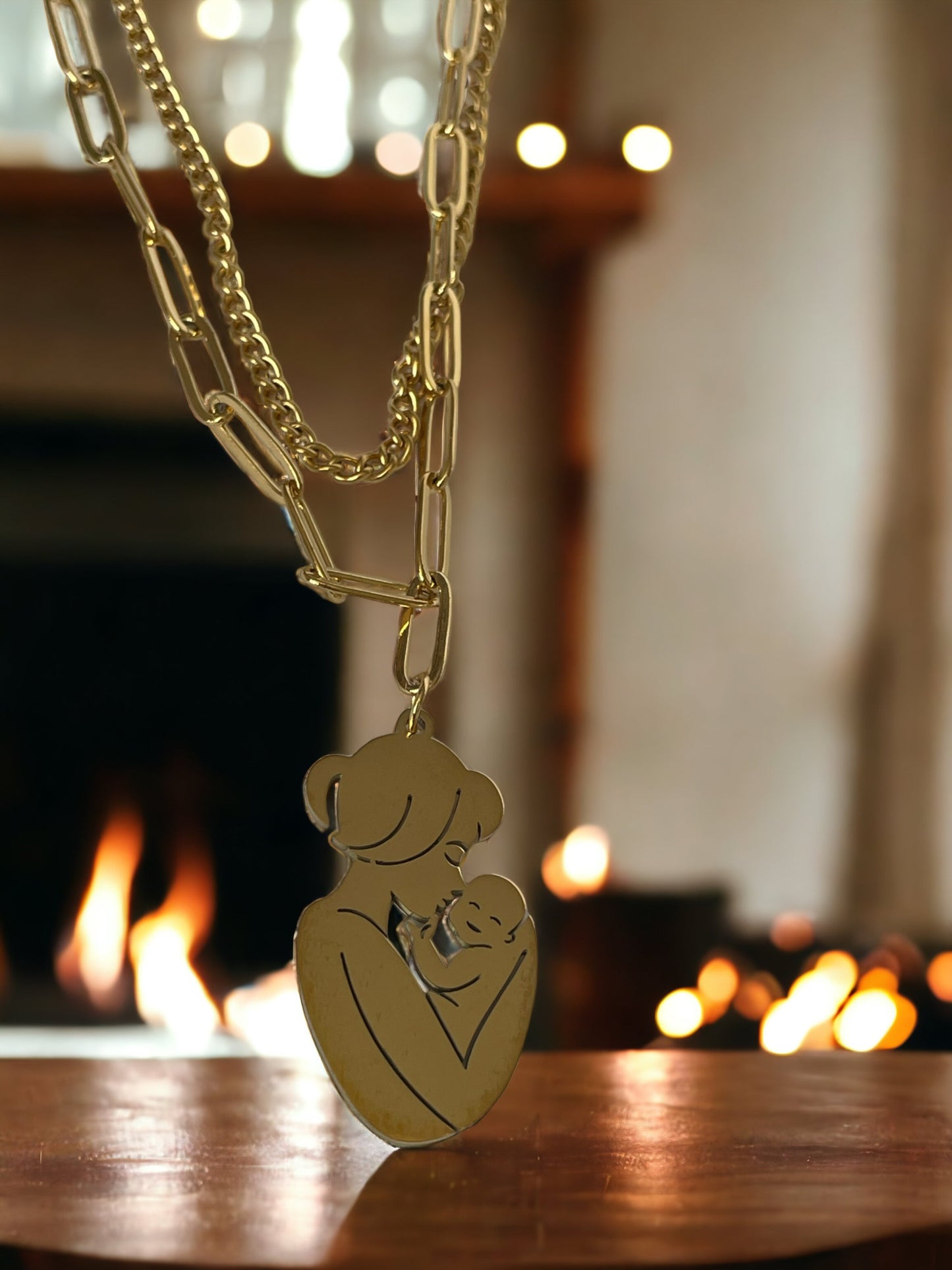 The Maternal Grace Pendant Necklace features a sophisticated design with a mother and her baby in a gentle embrace, forming an abstract heart shape within the pendant. Depending on your selection, the pendant comes in the resilient sheen of stainless steel or the timeless elegance of gold plating. The accompanying chain is tastefully designed to complement the pendant, making the necklace a graceful statement of motherly love and tenderness.