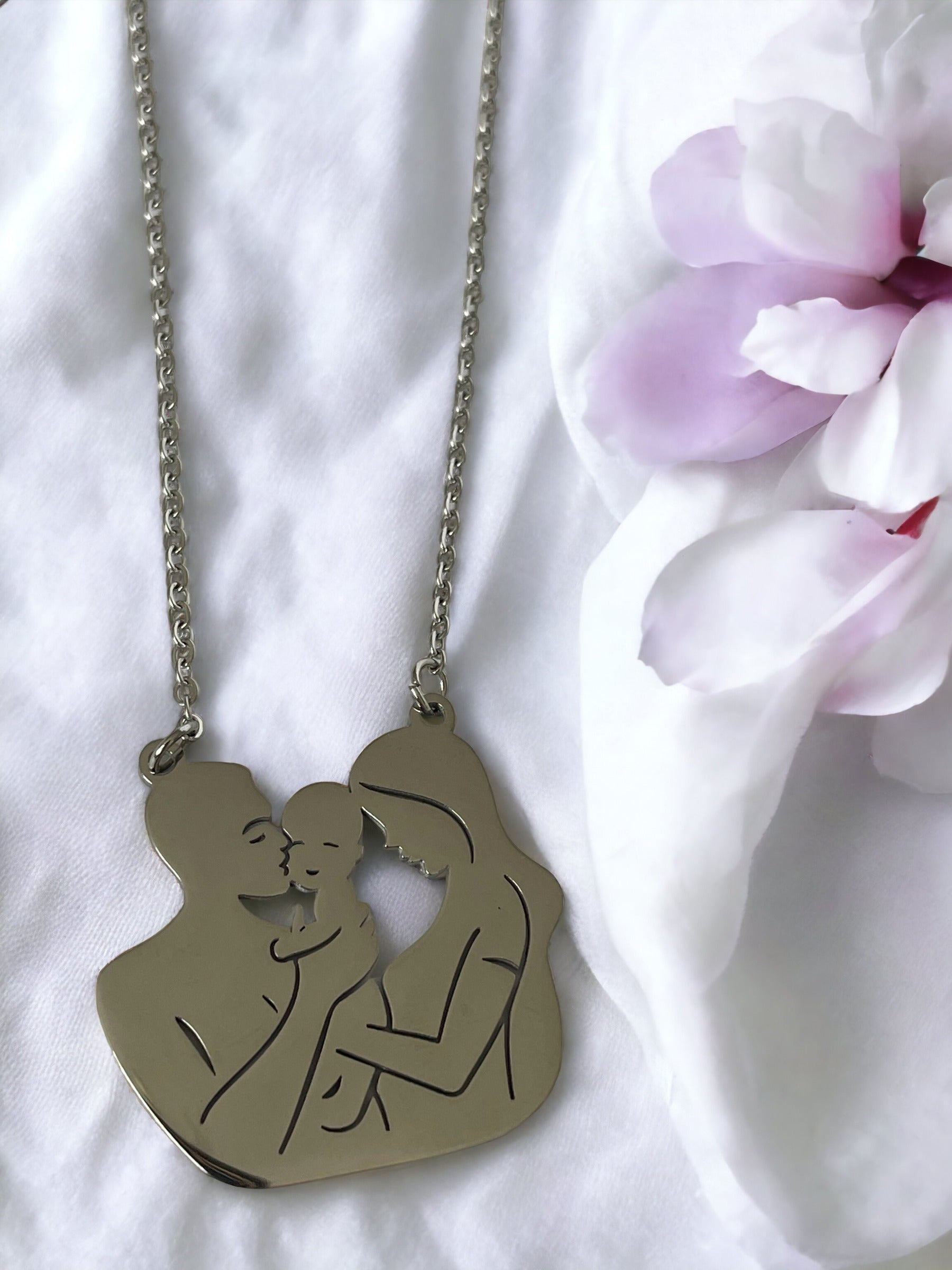 Embrace the tender connection of motherhood with our Mother & Child Silhouette Necklace. Each piece is meticulously crafted from the highest quality stainless steel, ensuring a lasting shine and durability. The pendant captures the precious bond between a mother and her child in a delicate silhouette, creating a powerful symbol of love and unity.
