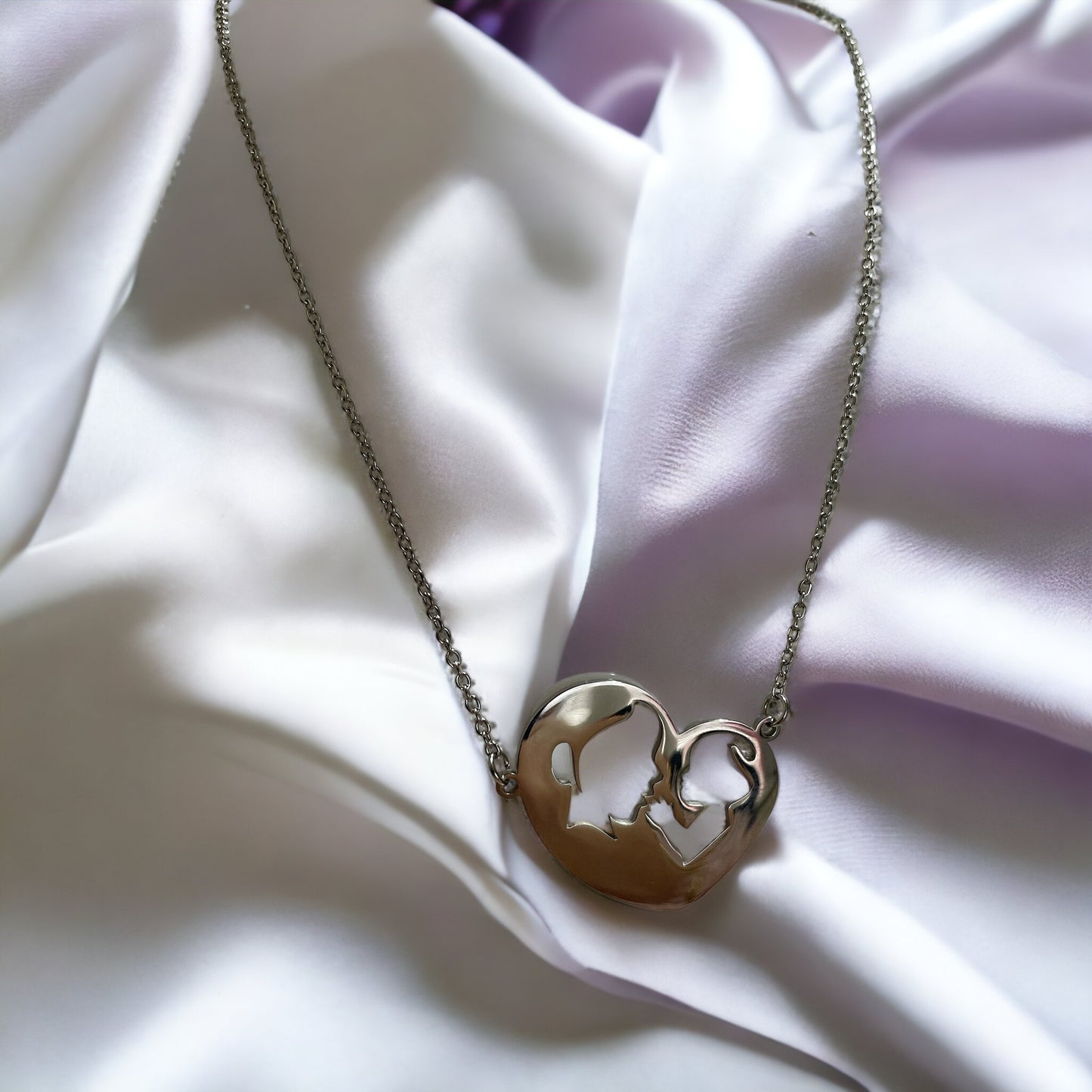 Embrace the elegance of simplicity with our Harmony Heart Necklace. Crafted with precision, this piece captures the essence of affection and togetherness with its interlocking profile design nestled within a heart's silhouette.