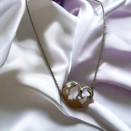 Embrace the elegance of simplicity with our Harmony Heart Necklace. Crafted with precision, this piece captures the essence of affection and togetherness with its interlocking profile design nestled within a heart's silhouette.