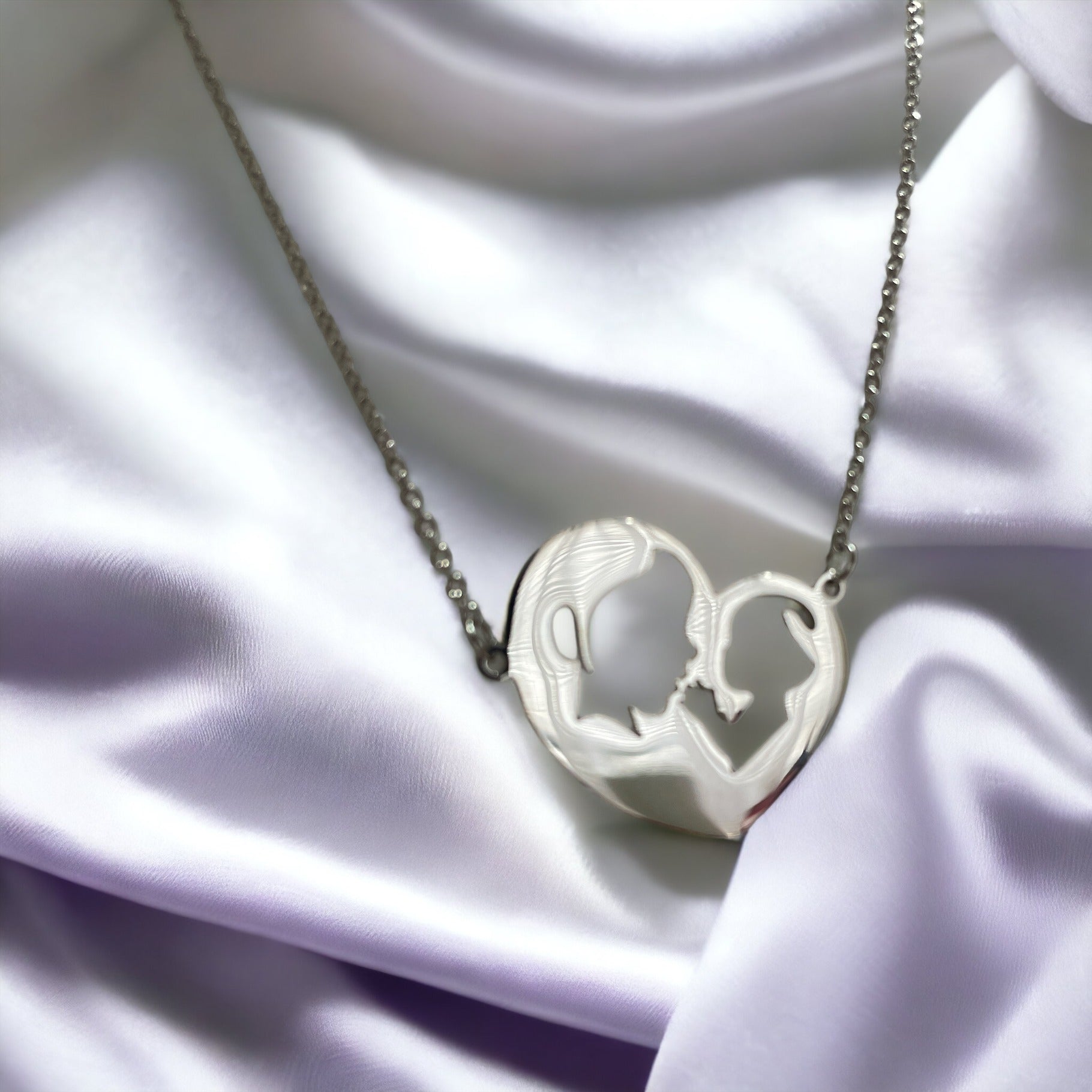 Embrace the elegance of simplicity with our Harmony Heart Necklace. Crafted with precision, this piece captures the essence of affection and togetherness with its interlocking profile design nestled within a heart's silhouette.