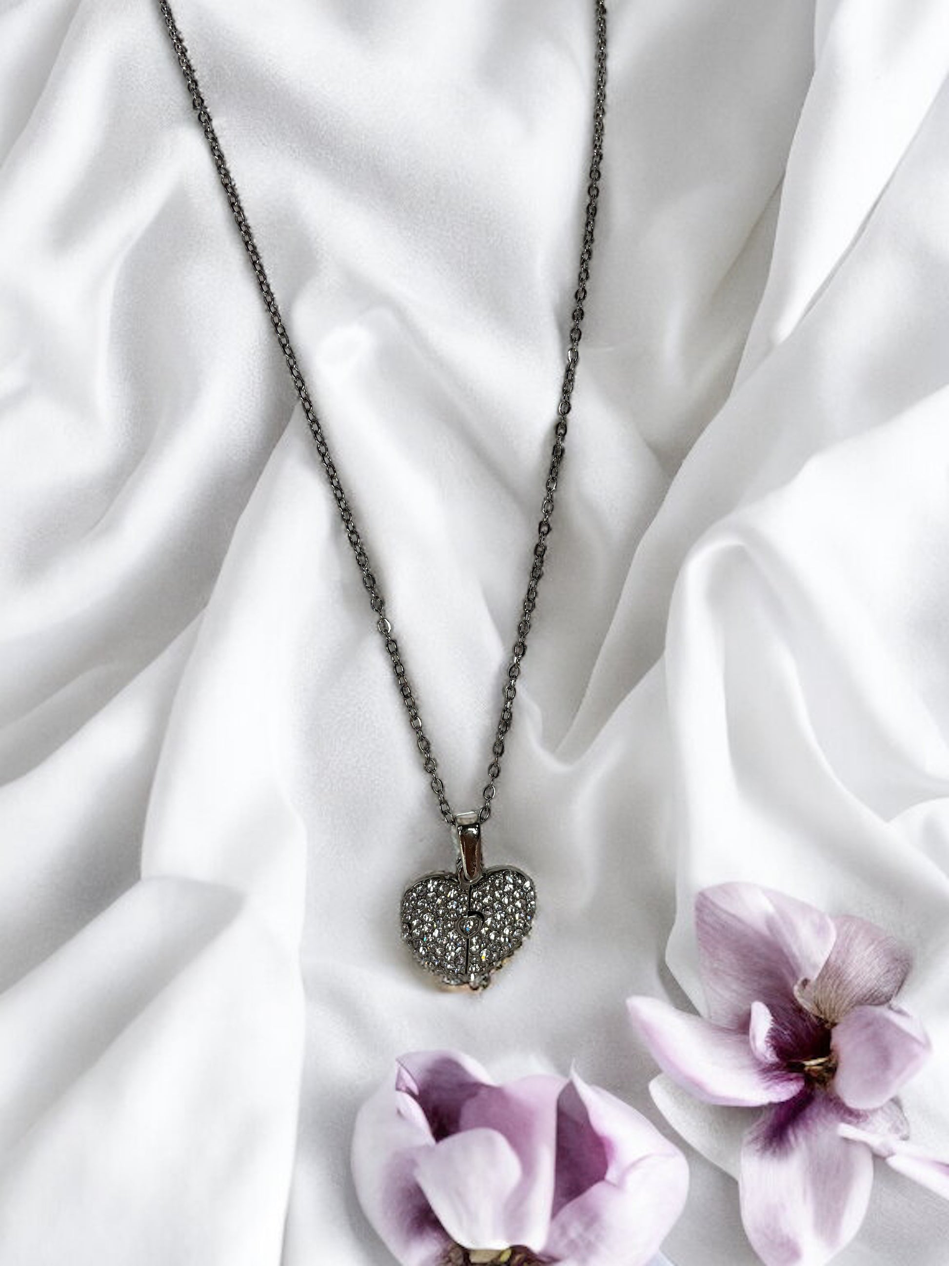 This enchanting piece captures the essence of togetherness, with two sets of footprints intertwined to form a heart, symbolizing the precious steps taken together by loved ones.  Available in both the timeless elegance of stainless steel and the warm glow of gold plating, this necklace is a versatile accessory that adds a touch of grace to any outfit. The heart at the center is a gentle reminder of the love that guides us and the shared experiences that shape our bonds.