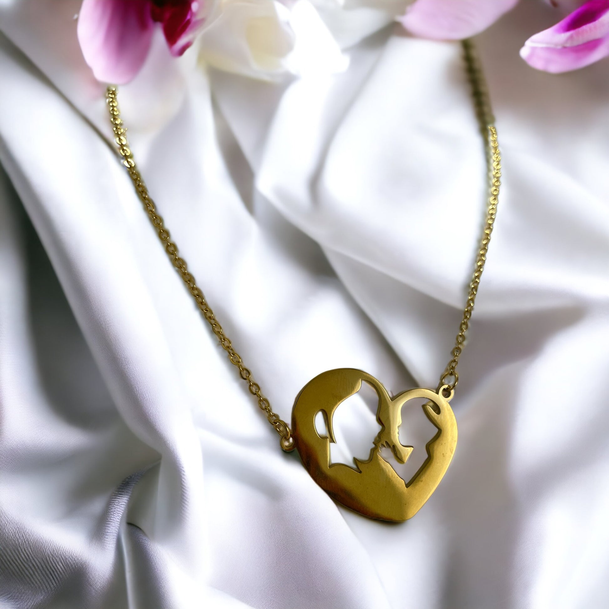 Embrace the elegance of simplicity with our Harmony Heart Necklace. Crafted with precision, this piece captures the essence of affection and togetherness with its interlocking profile design nestled within a heart's silhouette.