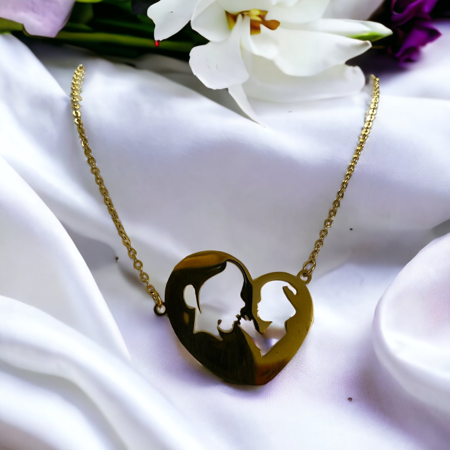 Embrace the elegance of simplicity with our Harmony Heart Necklace. Crafted with precision, this piece captures the essence of affection and togetherness with its interlocking profile design nestled within a heart's silhouette.