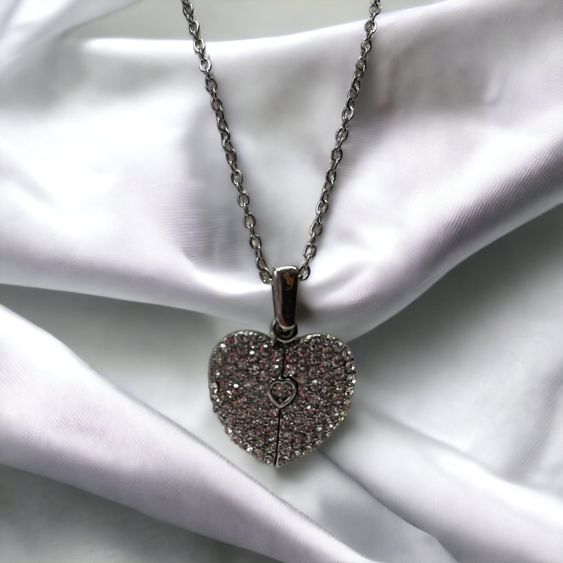This enchanting piece captures the essence of togetherness, with two sets of footprints intertwined to form a heart, symbolizing the precious steps taken together by loved ones.  Available in both the timeless elegance of stainless steel and the warm glow of gold plating, this necklace is a versatile accessory that adds a touch of grace to any outfit. The heart at the center is a gentle reminder of the love that guides us and the shared experiences that shape our bonds.