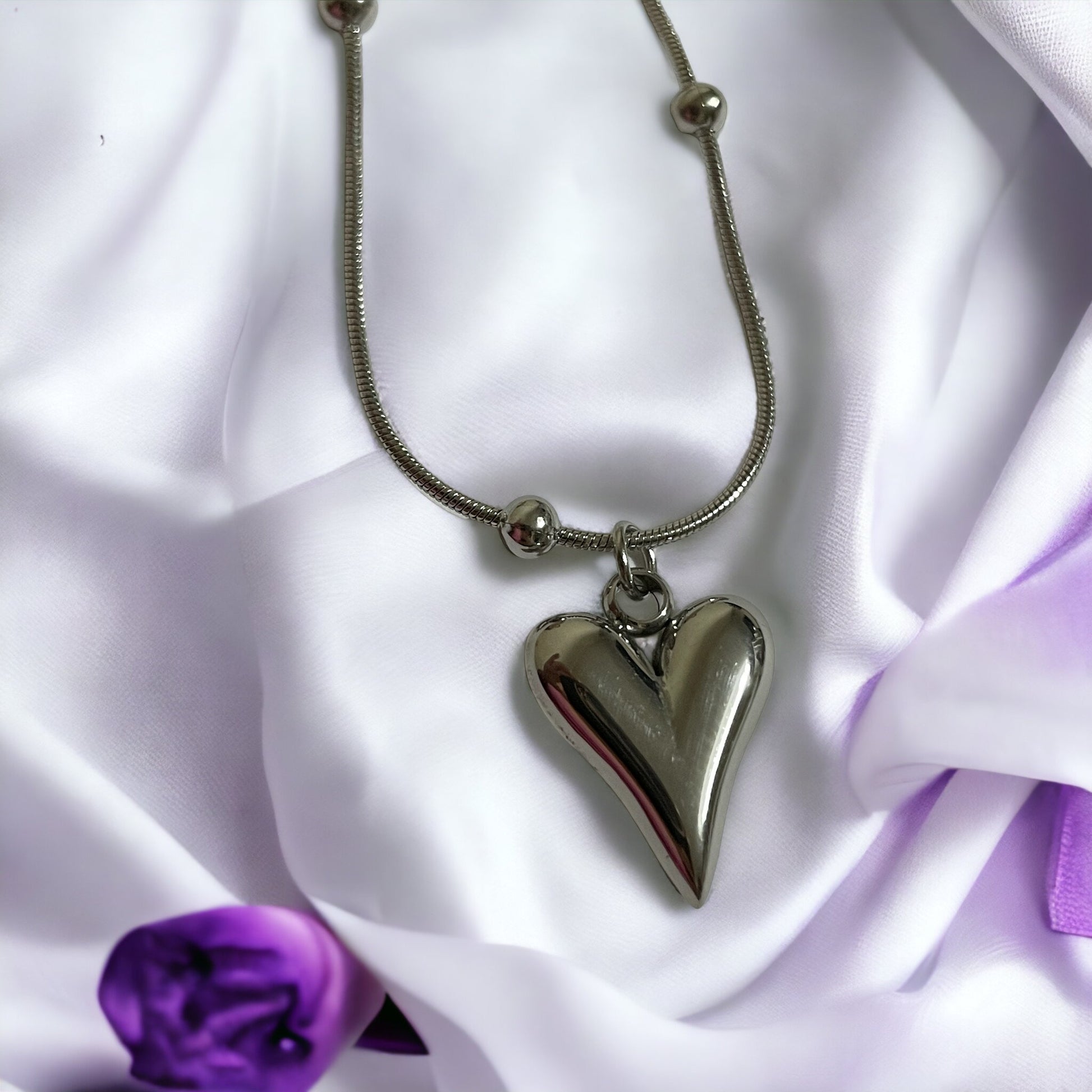 Introducing our Golden Heart Necklace – a modern twist on classic love. This exquisite piece is fashioned from premium stainless steel with a gleaming gold finish, offering both durability and a touch of sophistication. The heart-shaped pendant is polished to a mirror shine, hanging gracefully from a delicate chain adorned with spherical accents.