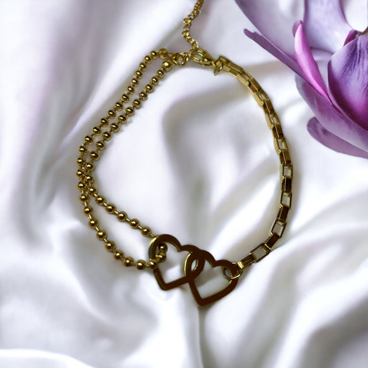Material: High-quality stainless steel for endurance and longevity. Plating: Gorgeous gold plating for a radiant shine. Design: Two linked hearts represent love and togetherness. Chain: A chic blend of bead and link chain offers a contemporary look. Closure: Adjustable clasp ensures a comfortable fit for any wrist size.