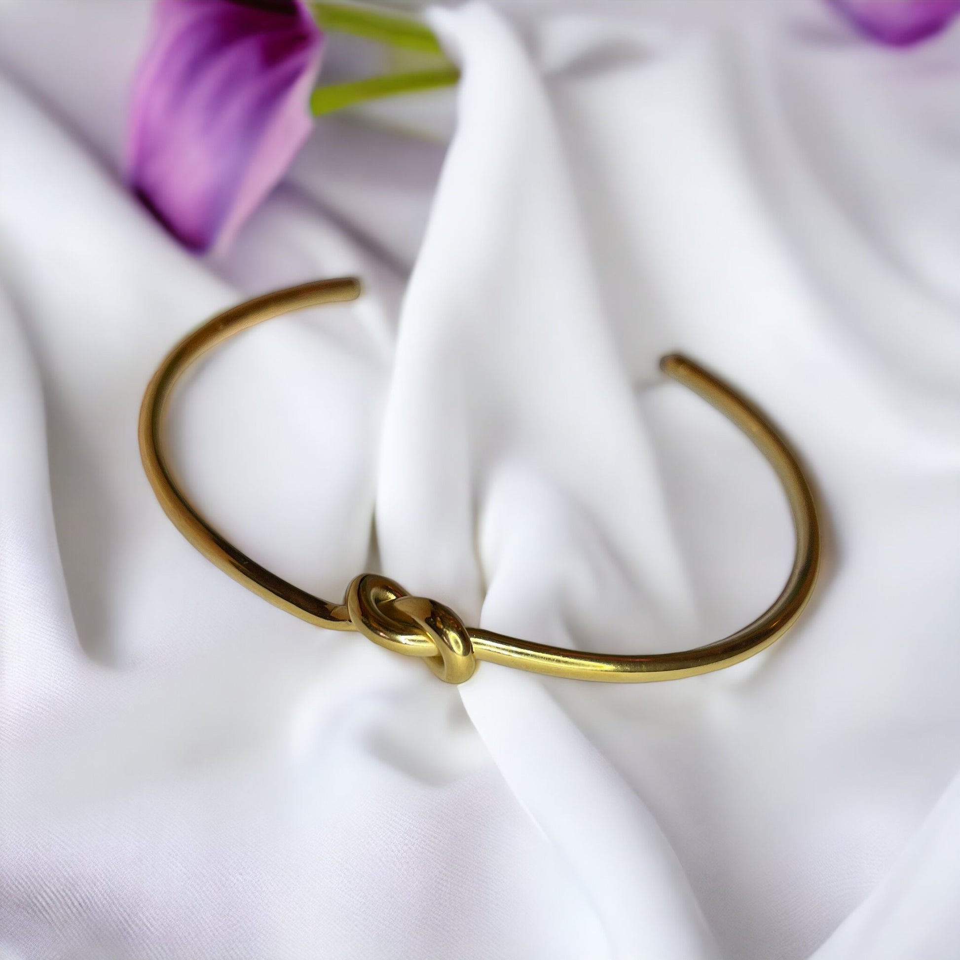 Infinite Embrace Bracelet is a sophisticated accessory designed to symbolize the unending strength of love and connection. It is adjustable in size and can comfortably fit most wrists.The bracelet's most distinctive feature is its clasp, which consists of two parts that interlock in a seamless fashion. The design resembles an infinite loop, reflecting a timeless bond or relationship.