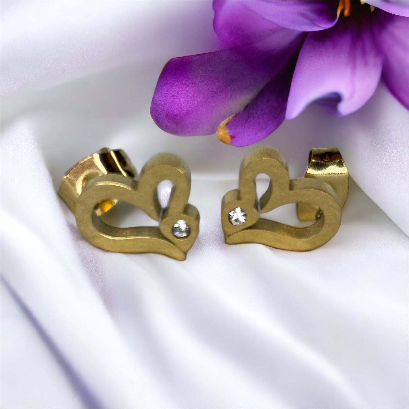 The Ariel Earrings are a testament to love's enduring strength and the beauty  Each piece features a polished surface that reflects light beautifully, accompanied by a sparkling gemstone that glimmers like a drop of ocean dew. These earrings are more than just an accessory; they are a keepsake that will carry the warmth of affection and the whispers of love.