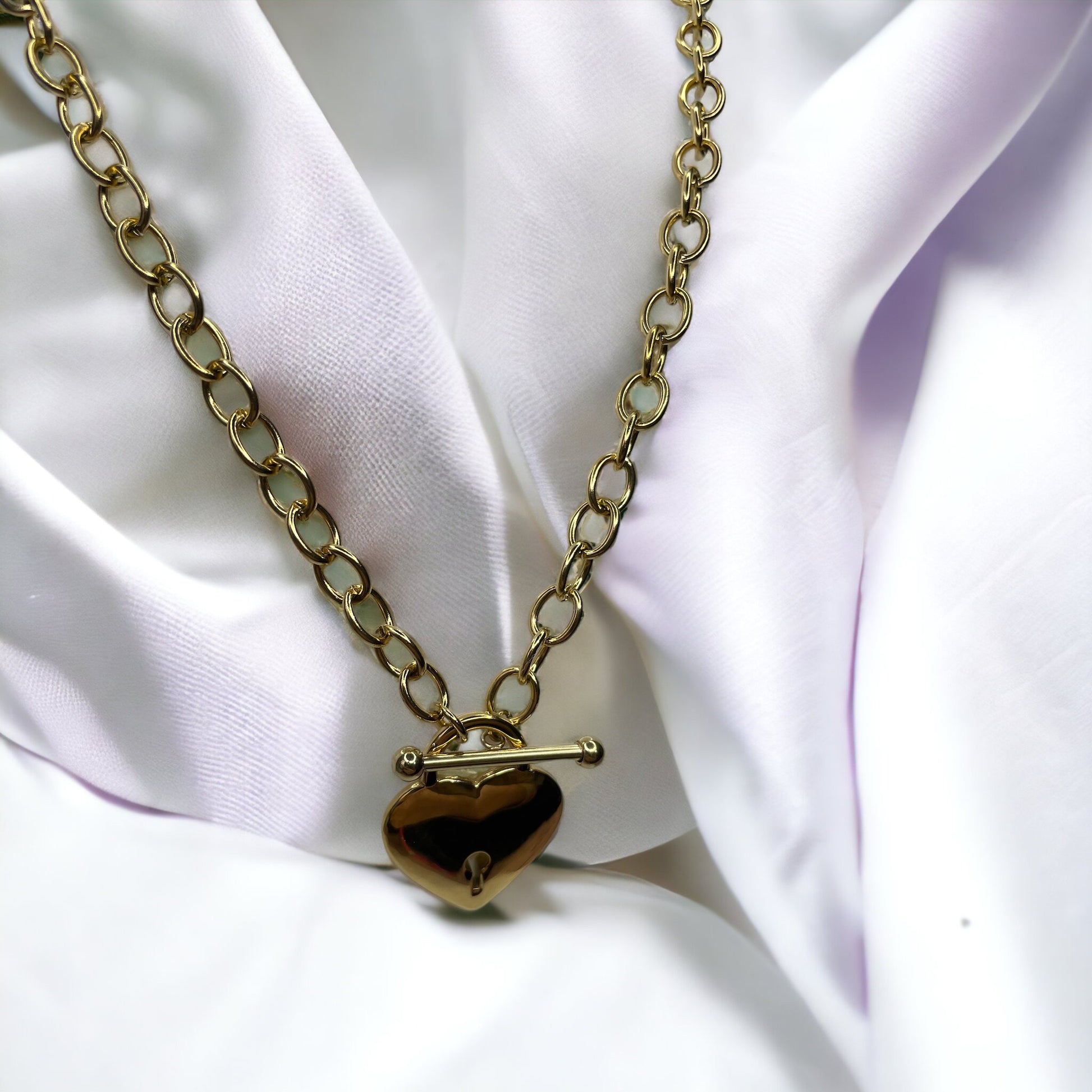 Unveil the Locket of Love Necklace, a masterpiece that combines contemporary style with a nostalgic touch. Crafted from durable stainless steel with an elegant gold plated finish, this necklace features a unique heart-shaped locket pendant. 
