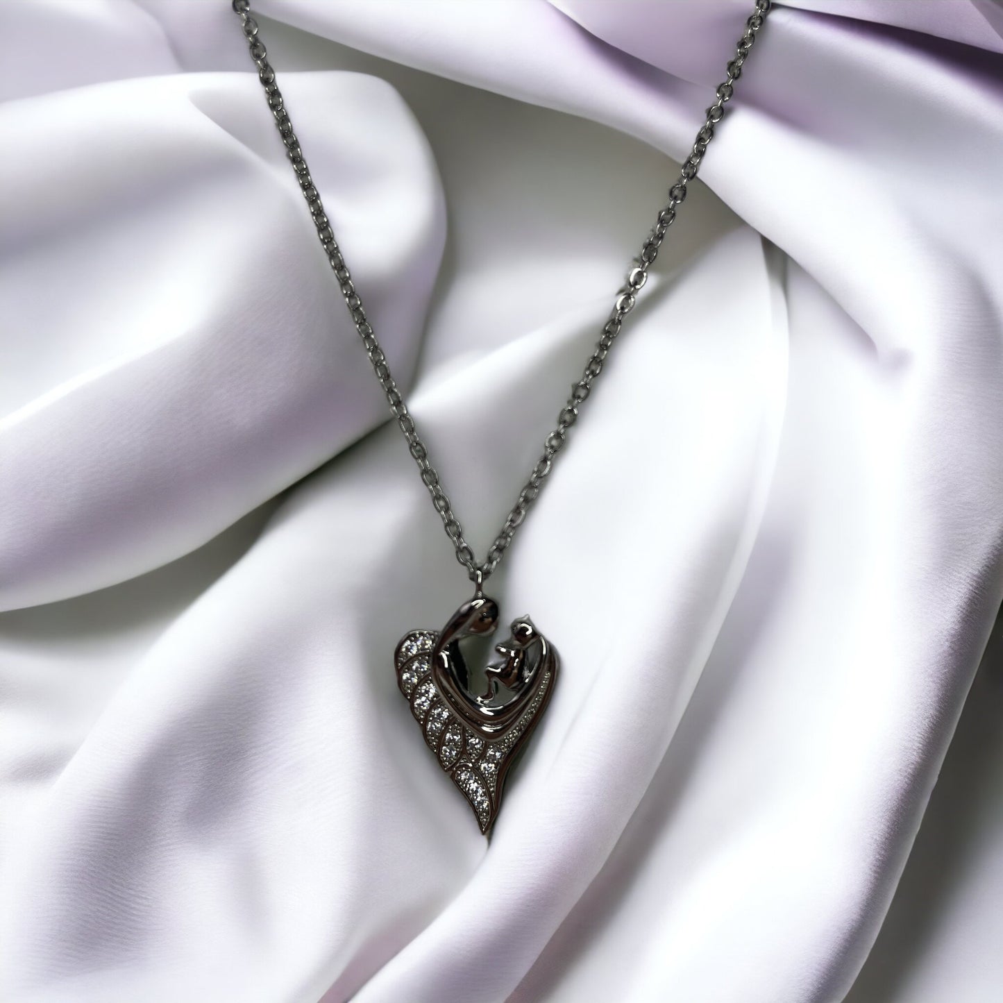 Revel in the sparkle of maternal affection with our Glittering Motherhood Necklace. This exquisite piece is crafted from premium stainless steel with a gold finish that radiates warmth. The pendant is shaped in an abstract form of a mother and child, their forms blending seamlessly into a symbol that speaks of infinite love