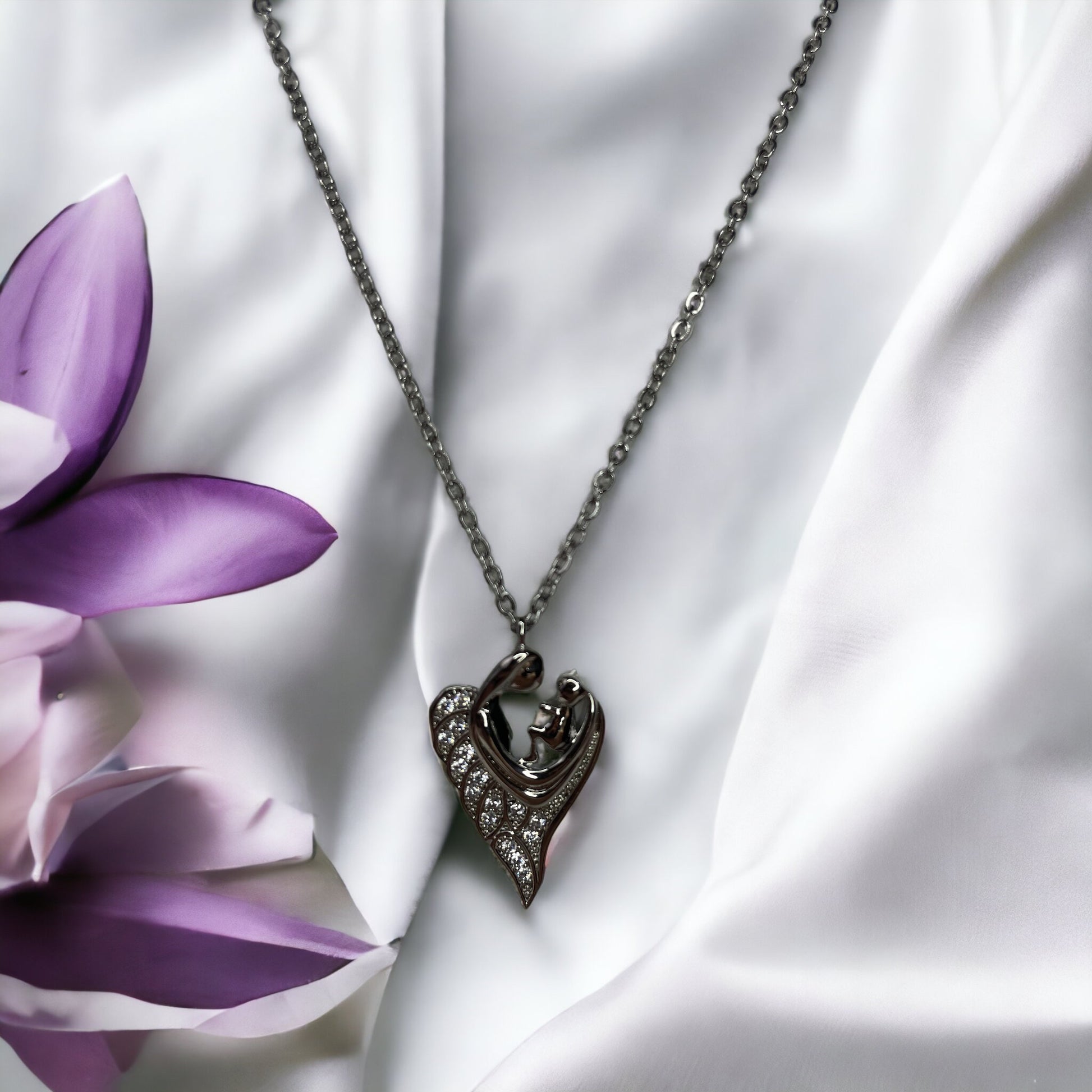 Revel in the sparkle of maternal affection with our Glittering Motherhood Necklace. This exquisite piece is crafted from premium stainless steel with a gold finish that radiates warmth. The pendant is shaped in an abstract form of a mother and child, their forms blending seamlessly into a symbol that speaks of infinite love