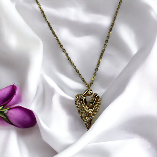 Revel in the sparkle of maternal affection with our Glittering Motherhood Necklace. This exquisite piece is crafted from premium stainless steel with a gold finish that radiates warmth. The pendant is shaped in an abstract form of a mother and child, their forms blending seamlessly into a symbol that speaks of infinite love
