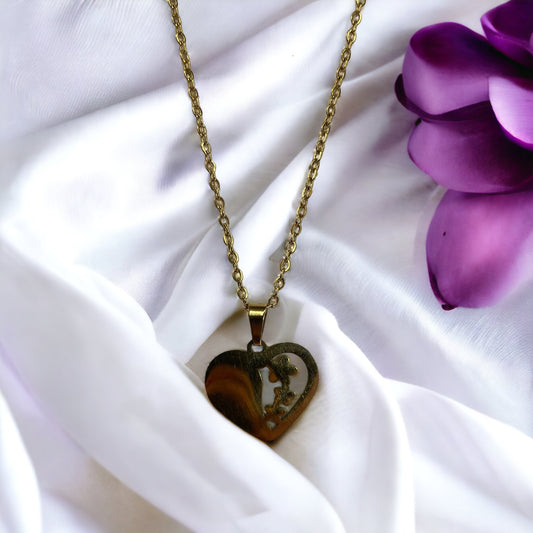 The 'Blossoming Trio' Necklace features a heart-shaped pendant enriched with the artistic depiction of three flowers in bloom, symbolizing the growth and unfolding stages of love. The pendant has a lustrous golden finish, indicating its gold-plated variant, with the choice of a durable stainless steel version as well. It hangs from a chain that matches in color and refinement, embodying love's enduring and ever-growing nature.