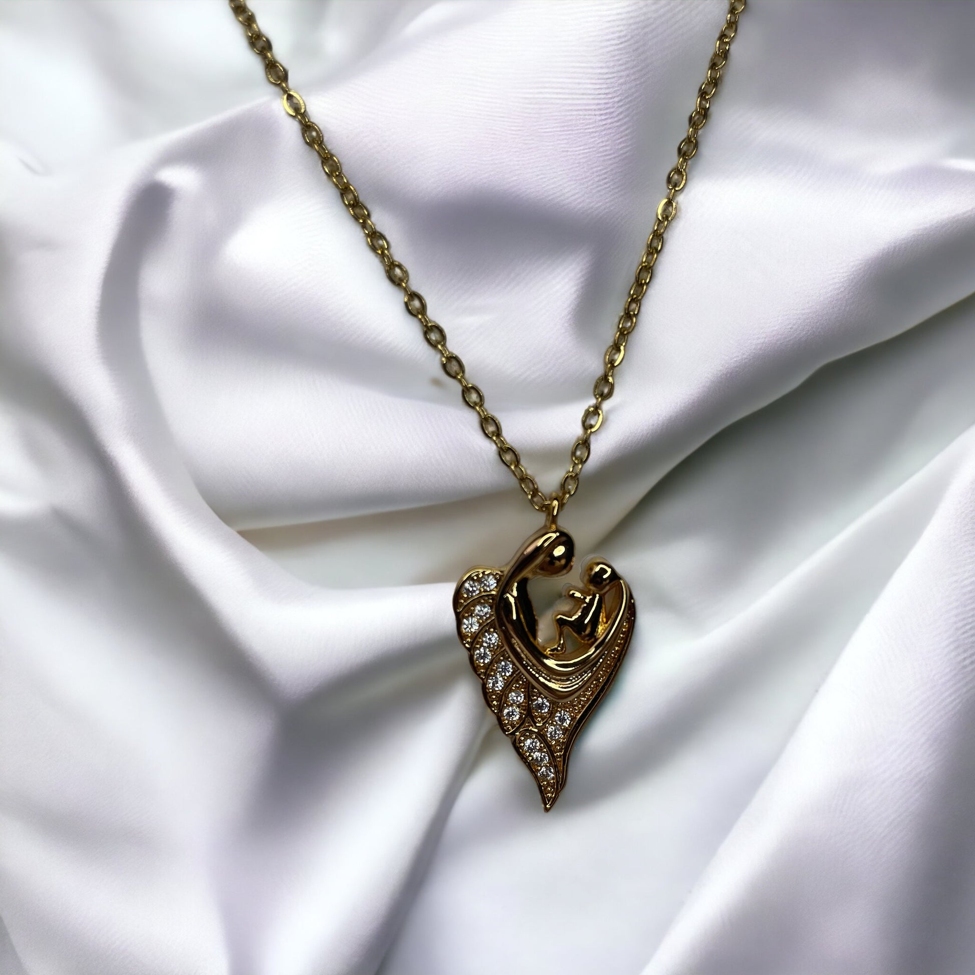 Revel in the sparkle of maternal affection with our Glittering Motherhood Necklace. This exquisite piece is crafted from premium stainless steel with a gold finish that radiates warmth. The pendant is shaped in an abstract form of a mother and child, their forms blending seamlessly into a symbol that speaks of infinite love